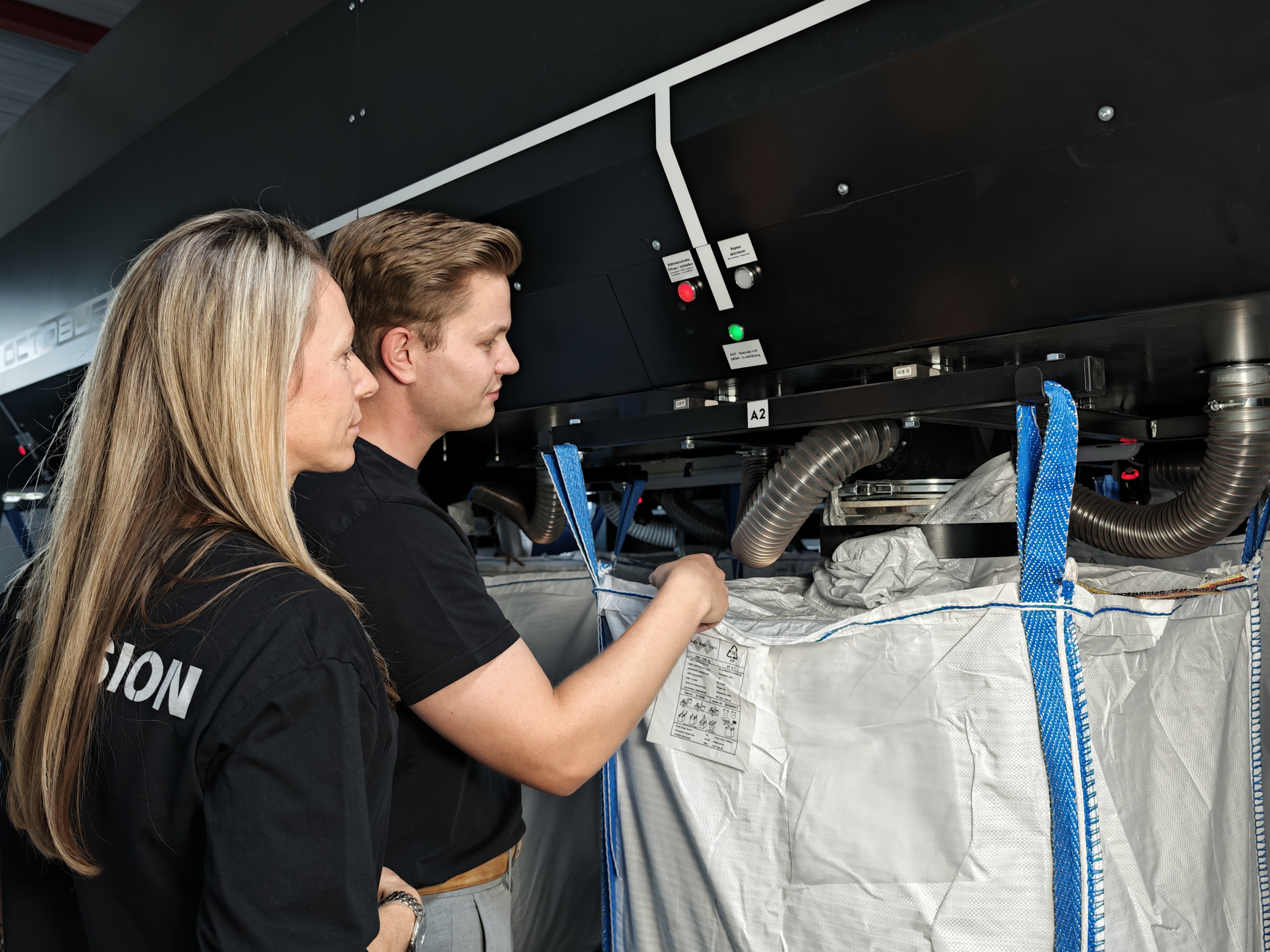 Two Carbon Cleanup team members working together at the CARB-E and OCTOBUS system