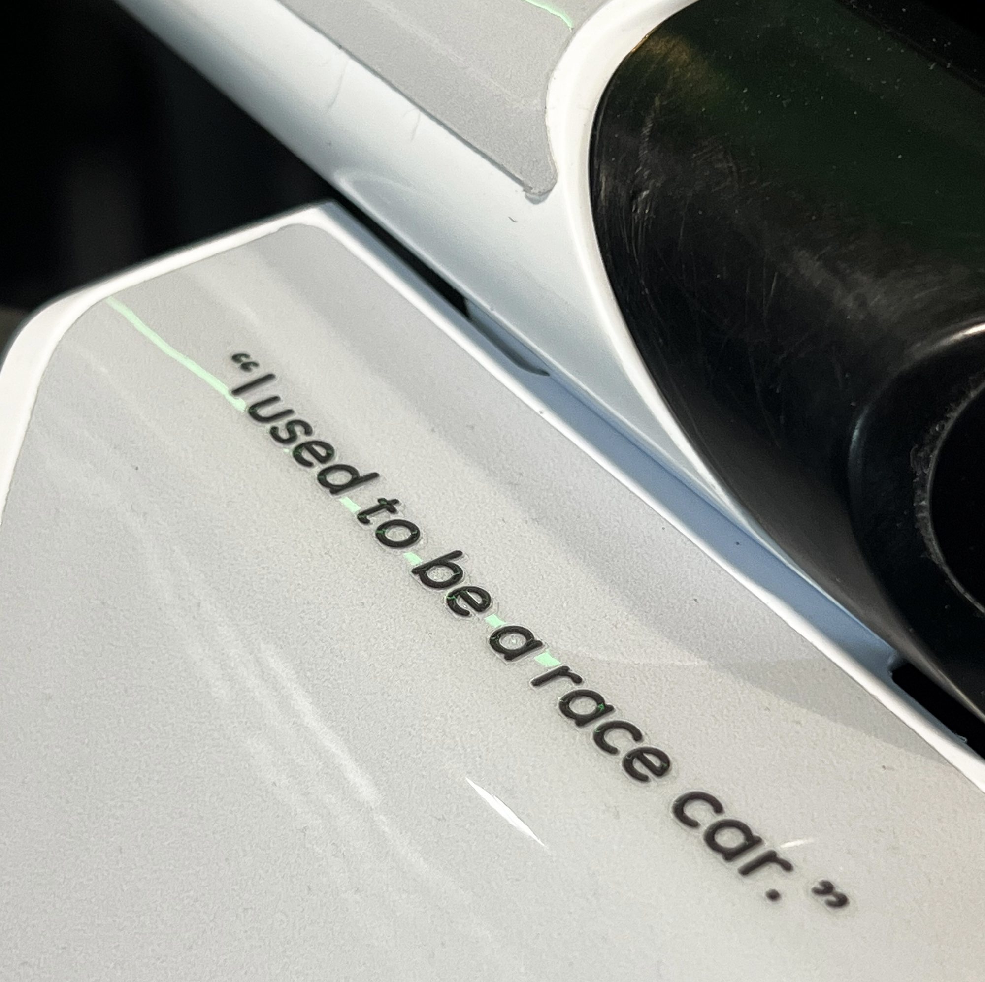 A recycled composite part marked with the words 'I used to be a race car'